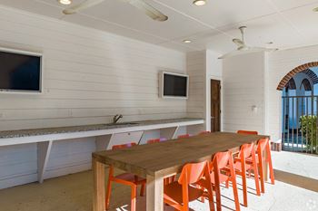 Outdoor covered kitchen area with grilling stations & tvs